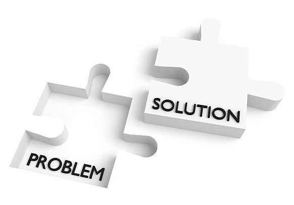 Two white puzzle pieces labeled "PROBLEM" and "SOLUTION" separated on a white background, representing problem-solving.