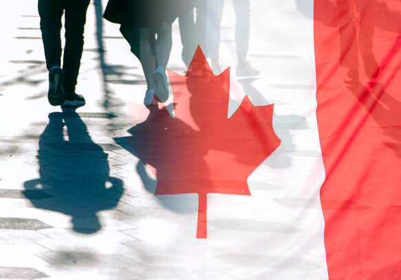 Canadian flag overlaid with walking pedestrian shadows, showing red maple leaf against white background